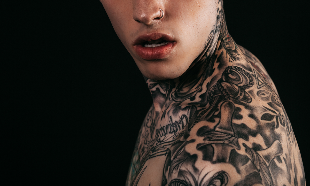 Side profile of heavily tattooed guy.