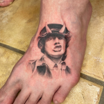 patayin-acdc-angus-young-tattoo Angus Young from AC/DC realism tattoo on the foot.