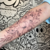 Family floral fine-line bouquet tattoo.