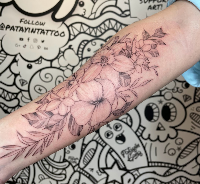 Family floral fine-line bouquet tattoo.