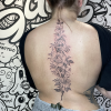 Back floral tattoo for women.