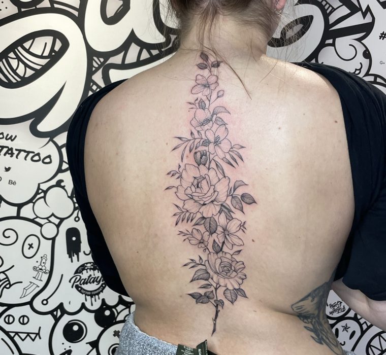 Back floral tattoo for women.