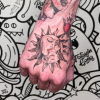Retro girl in sun on hand tattoo.