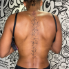 Floral spine tattoo