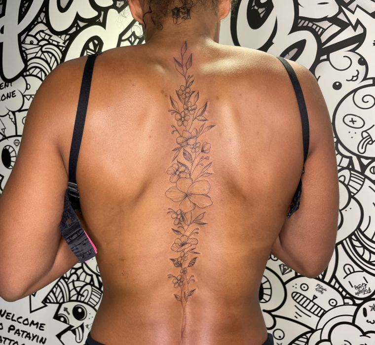 Floral spine tattoo