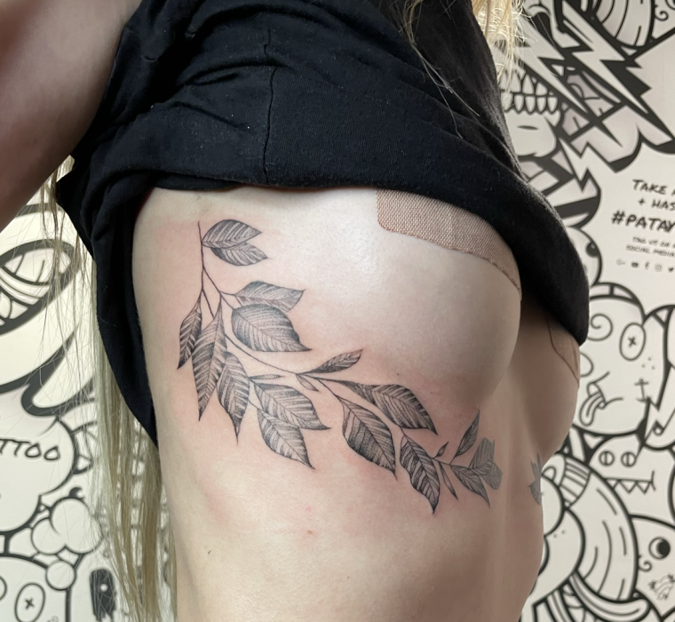 Under boob foliage tattoo