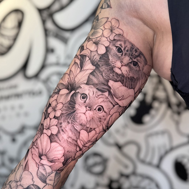 Scottish fold cat tattoo with flowers.