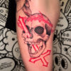 skull with inverted cross in black and red tattoo