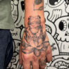 Frog and lotus hand tattoo