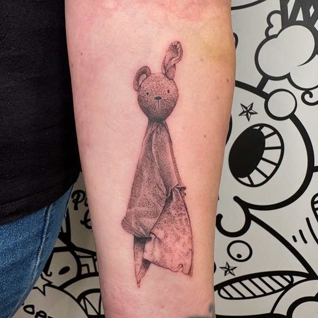 Kid's stuffy in pointillism and black/grey realism style tattoo